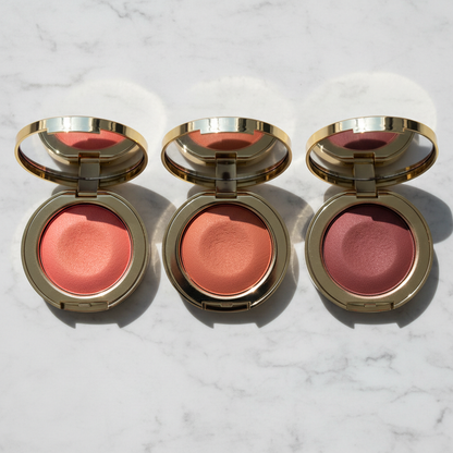 Three blush compact shades flat lay on white marble